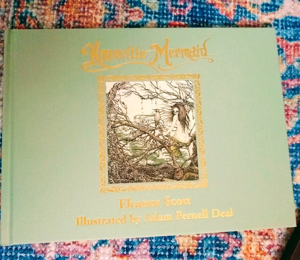 Closeup of "Knoxville Mermaid," with green linen cover and gold lettering on the front. 